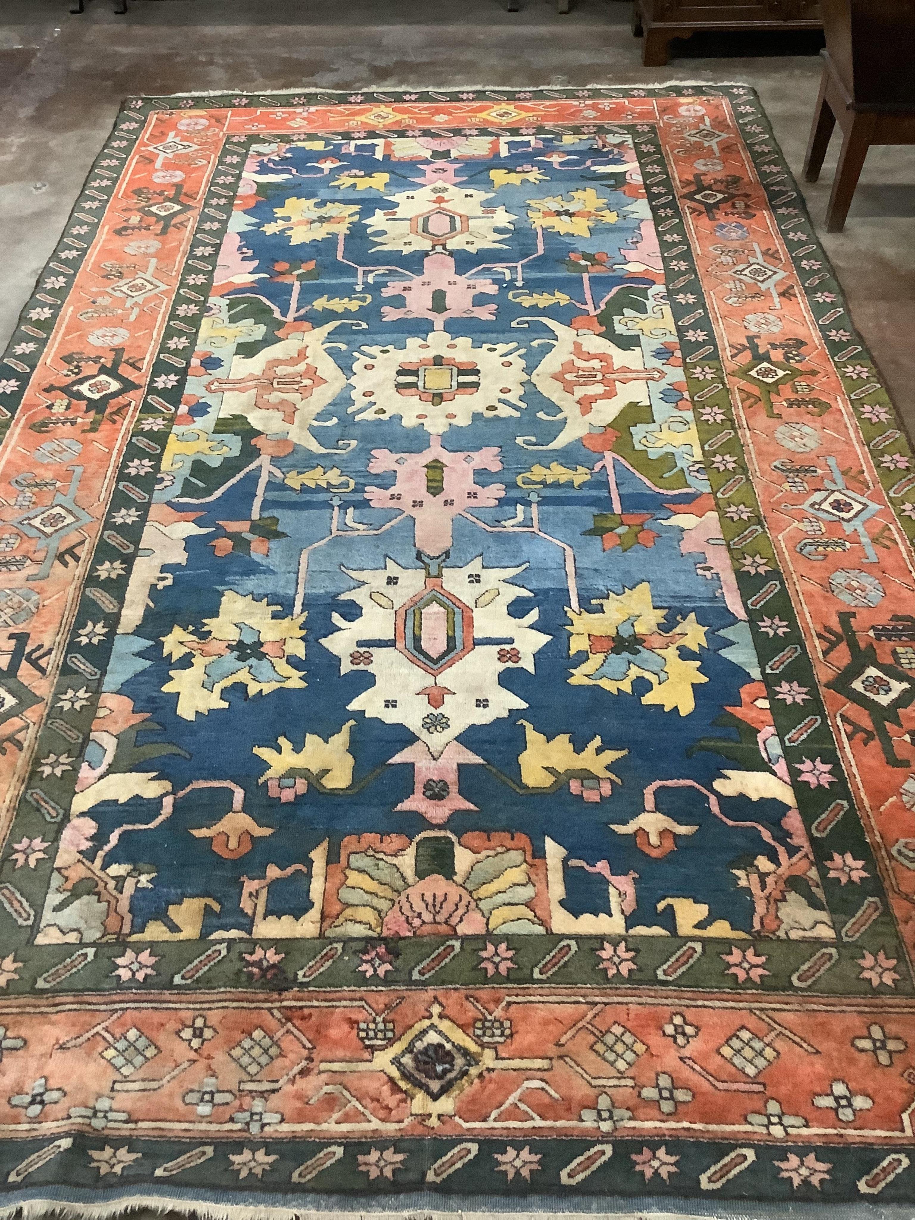 A Caucasian style polychrome carpet, with a blue field and red geometric border, 390 x 236cm. Condition - fair